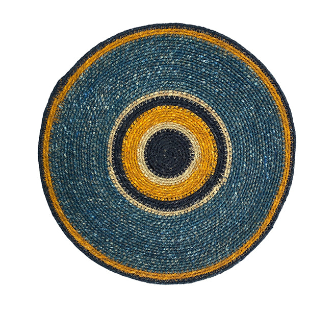 Round woven mat with concentric circle pattern in blue, yellow, and black on a white background