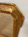Gold-framed mirror with decorative patterns on a white background