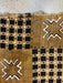 Textile with black and white geometric patterns on a beige background