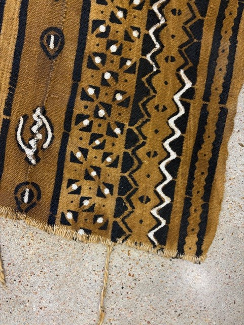 Textile with intricate patterns on a concrete surface