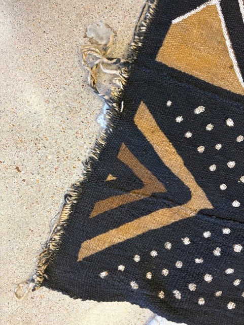 Decorative rug with geometric pattern on sand