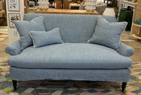Blue sofa with cushions in a store setting