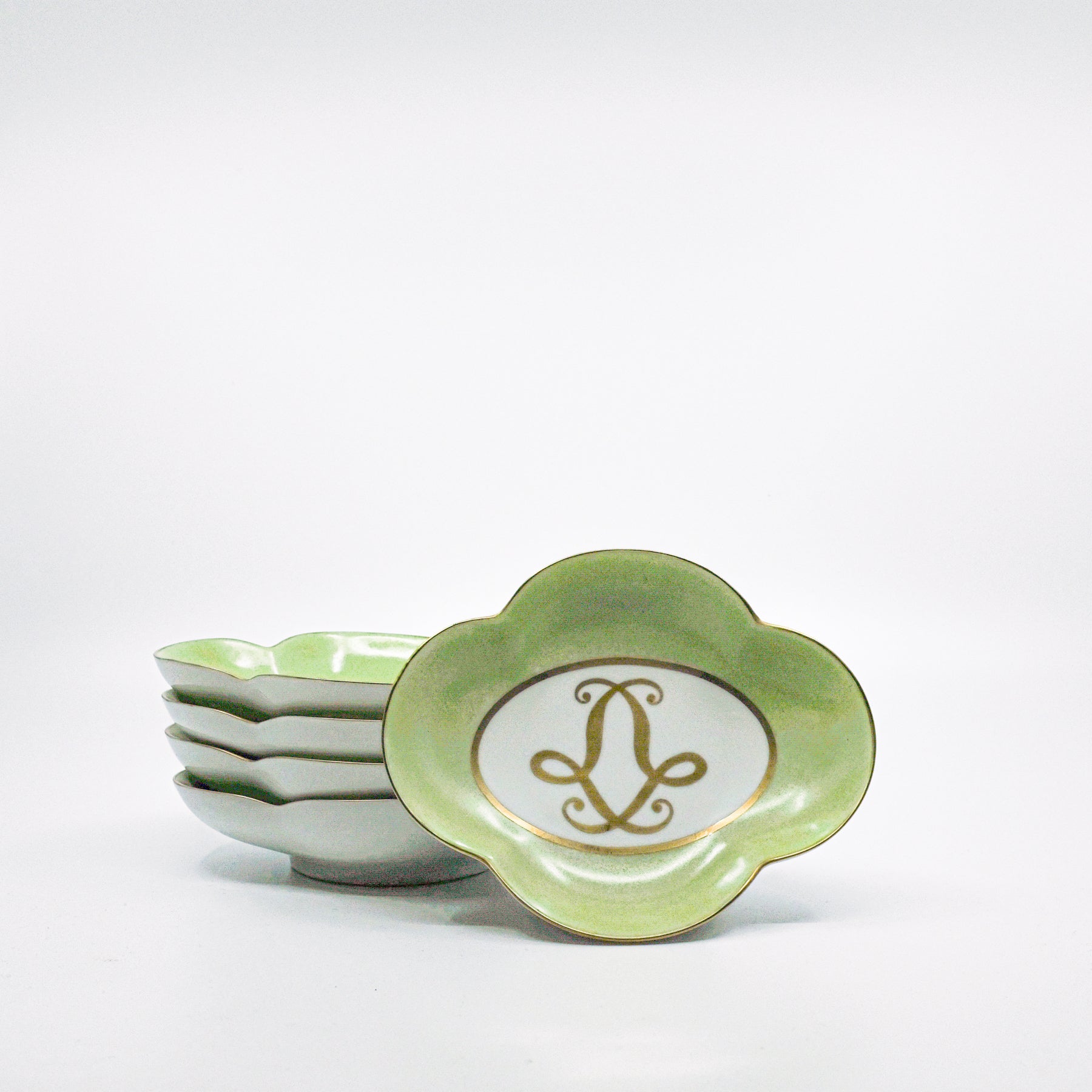 stack of green and white ceramic dishes