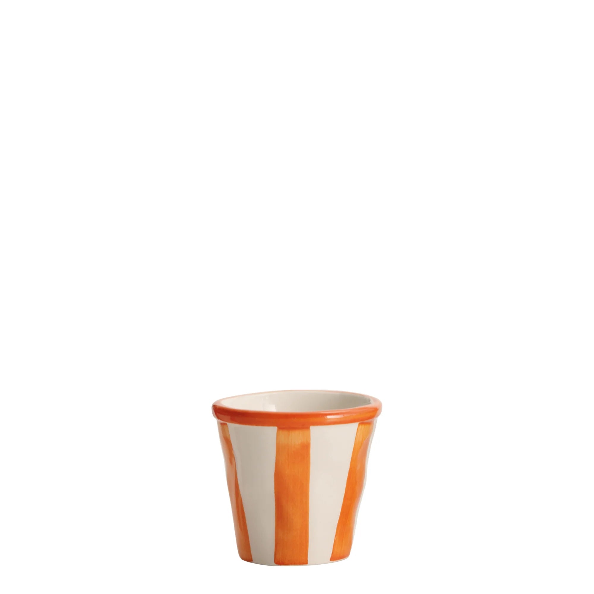 Ceramic cup with orange and white stripes on a white background