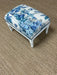 Floral-patterned ottoman on a brown carpet