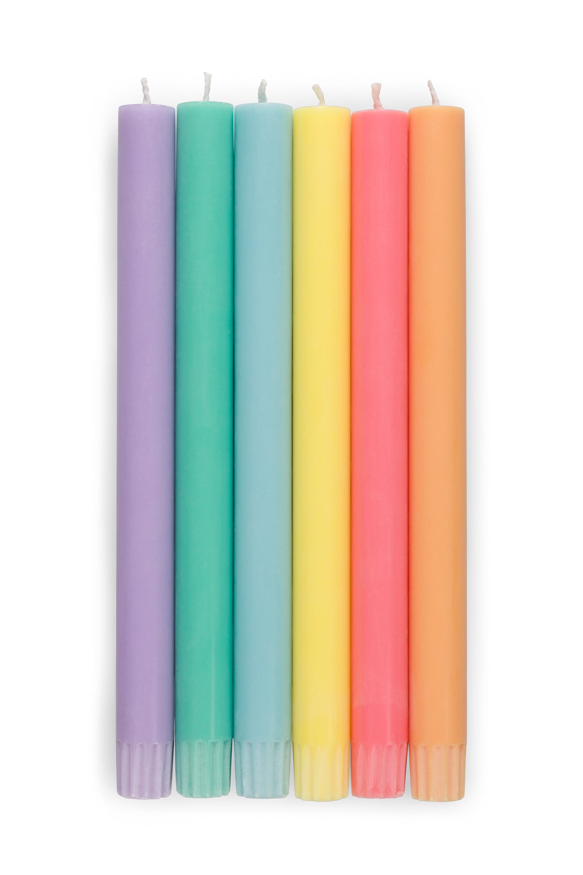 Set of six colorful candles in pastel shades on a white background