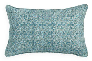 Teal patterned pillow on a white background