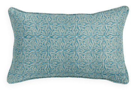 Teal patterned pillow on a white background