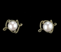 A pair of vintage-style stud earrings featuring round white pearls set in an ornate, textured antique bronze or silver-toned scrollwork frame, presented on a solid black background.