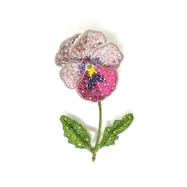 Decorative brooch with a pink flower design on a white background