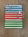 Set of three striped trays in blue, red, and green on a wooden surface.