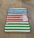 Set of three striped ceramic trays on a wooden surface