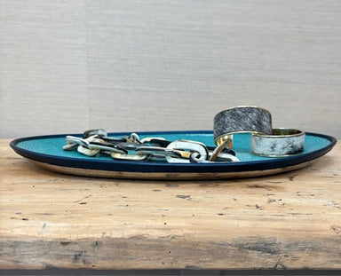 Blue ceramic tray with decorative elements on a wooden surface