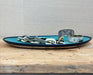 Blue ceramic tray with decorative elements on a wooden surface