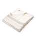 Folded beige coverlet with a brand logo on a white background