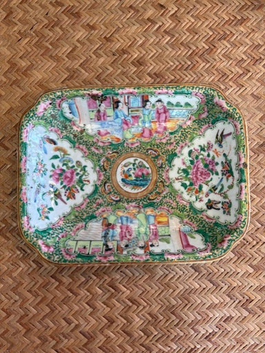 Decorative tray with intricate patterns on a woven surface