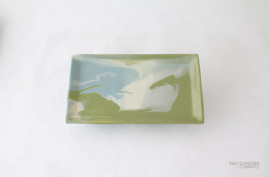Rectangular ceramic dish with green and blue abstract design on a white background, branded 'Paul Schneider Ceramics'.