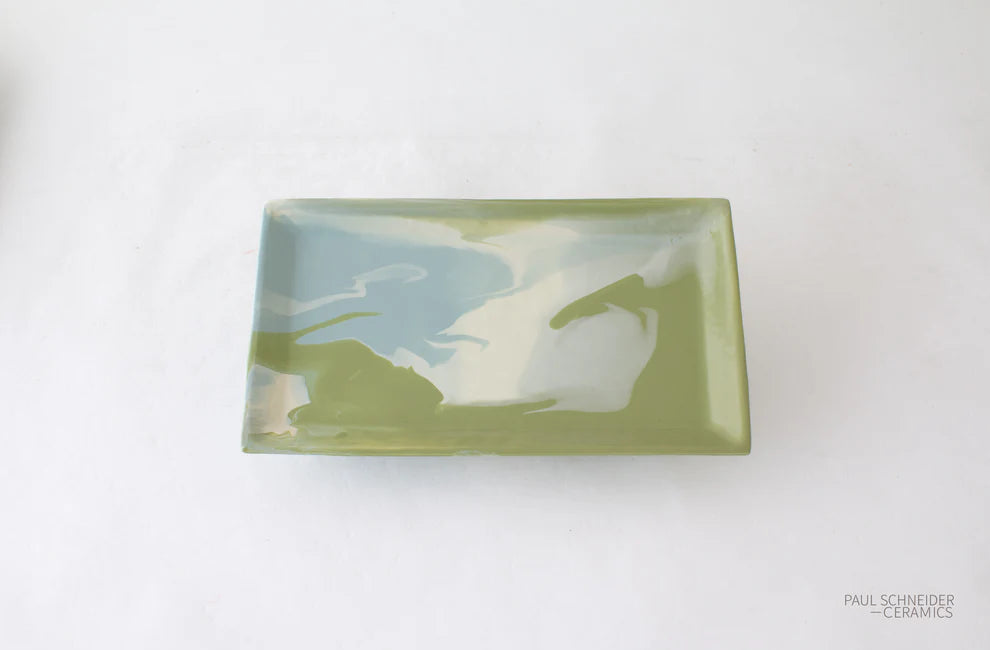 Rectangular ceramic dish with green and blue abstract design on a white background, branded 'Paul Schneider Ceramics'.