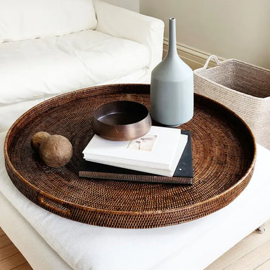 Wicker tray with decorative items on a white sofa