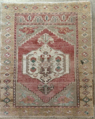 Decorative rug with geometric pattern on a wooden floor