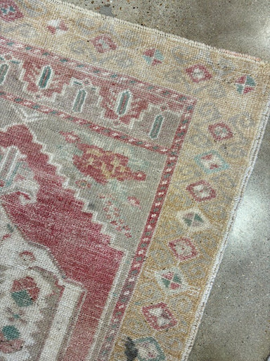 Close-up of a patterned rug on a concrete floor
