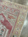 Close-up of a patterned rug on a concrete floor