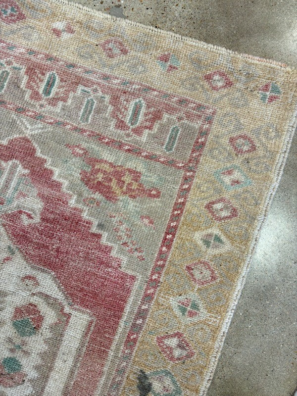 Close-up of a patterned rug on a concrete floor