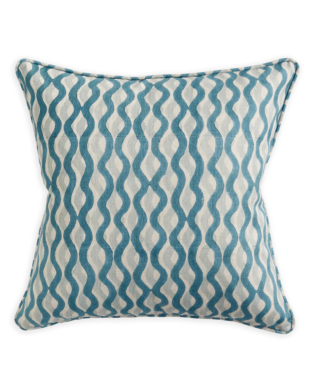 Decorative pillow with blue and white wavy pattern on a plain background