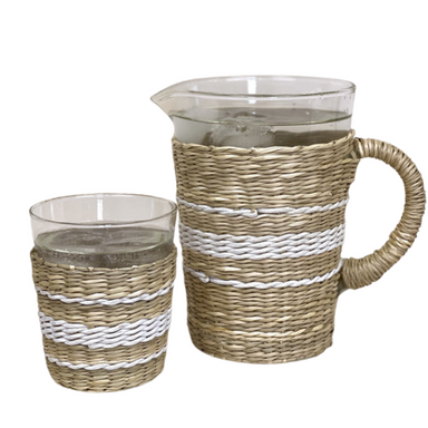 Wicker pitcher and glass set on a white background