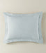 Light blue textured pillow on a beige background