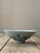 Ceramic bowl with blue floral patterns on a wooden surface