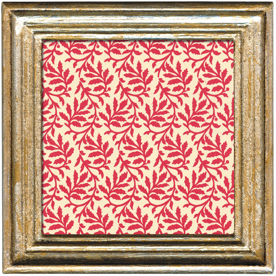 Framed fabric swatch with red leaf pattern on a beige background