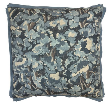 Floral patterned pillow with blue and beige colors on a white background
