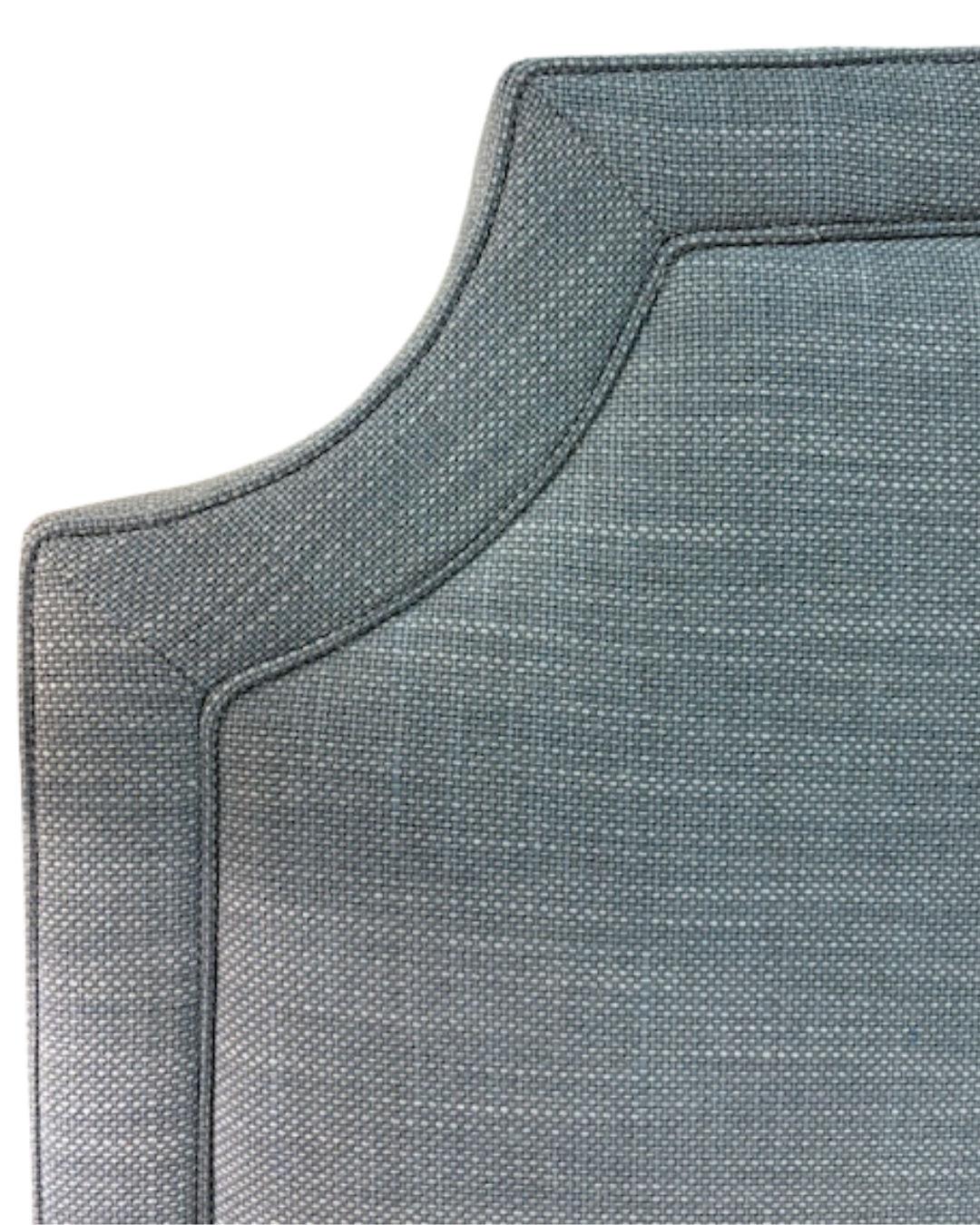 Close-up of a textured soft blue headboard corner