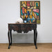 antique table set with champagne coupes in front of original art