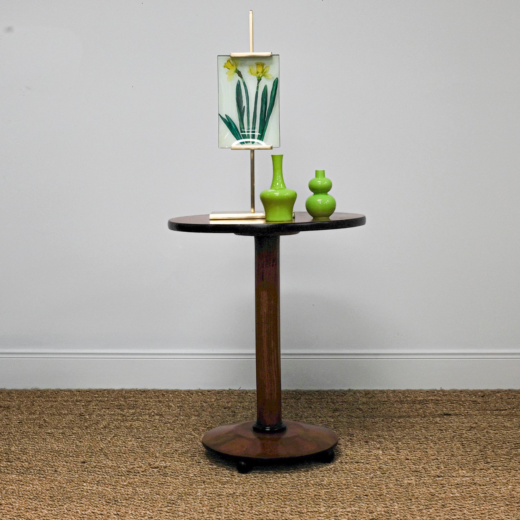 antique table set with green vases and artwork