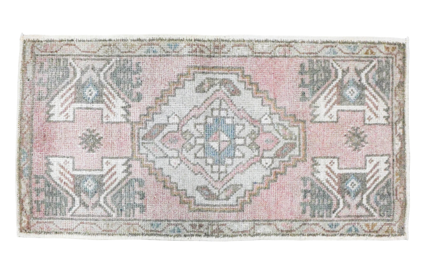 pale pink and blue centers in a wool rug