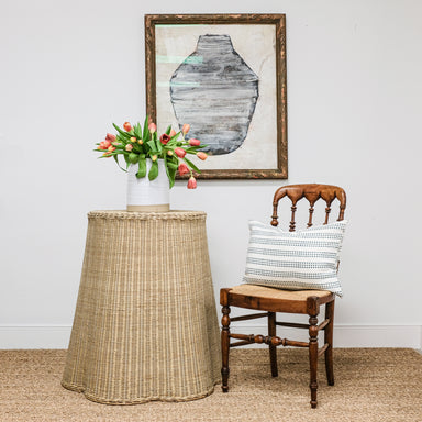 wicker table, antique chair, and painting