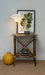 Small wooden side table with decorative items against a plain wall
