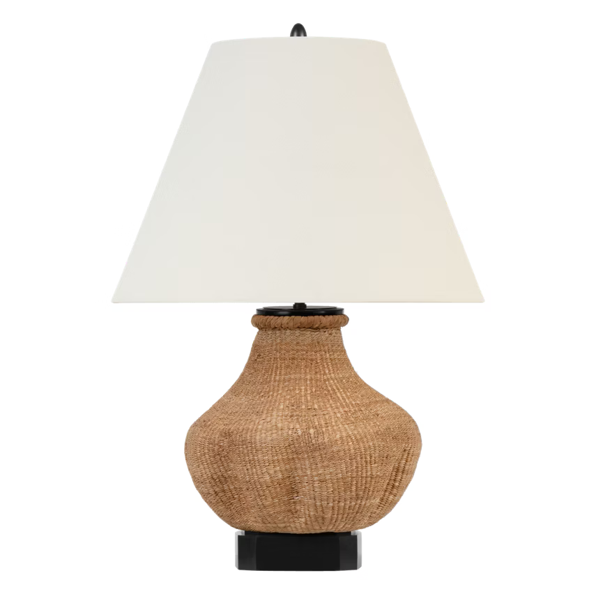 Table lamp with woven base and white shade on a transparent background