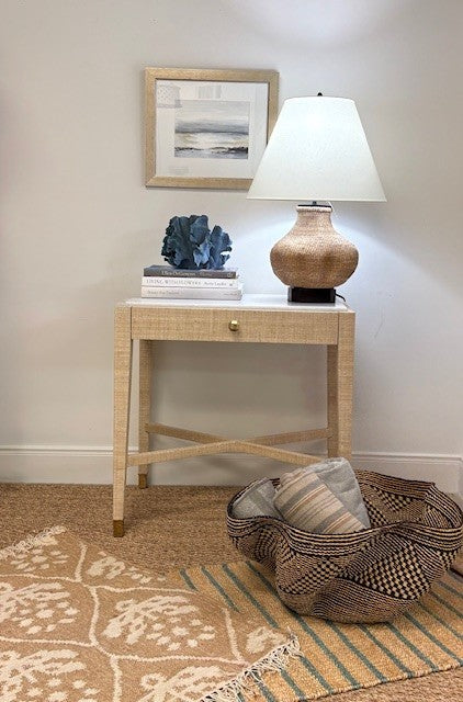 Nautical-themed room with a side table, lamp, and decorative items.
