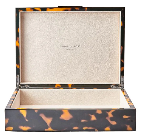 Tortoiseshell-patterned jewelry box with 'Addison Ross' branding on a white background
