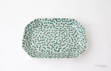 Rectangular ceramic plate with green dot pattern on a white background