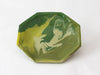 An octagonal shallow tray with a marbled green and yellow pattern, photographed on a clean white background.