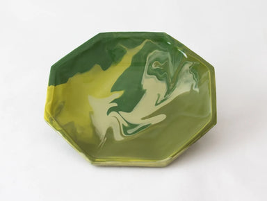 An octagonal shallow tray with a marbled green and yellow pattern, photographed on a clean white background.