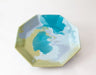 An octagonal ceramic tray with a marbled design featuring turquoise blue, light blue, pale green, and white swirls, photographed on a clean white background.