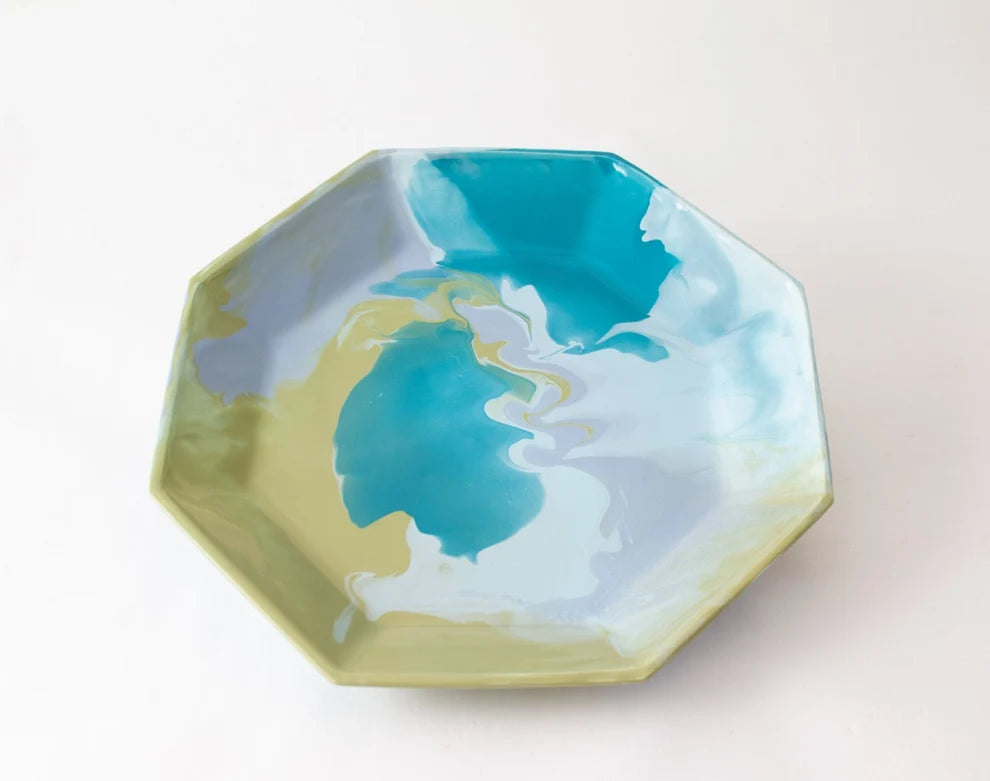 An octagonal ceramic tray with a marbled design featuring turquoise blue, light blue, pale green, and white swirls, photographed on a clean white background.