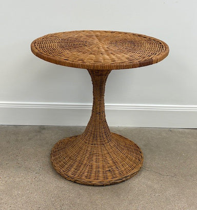 Wicker side table against a plain wall