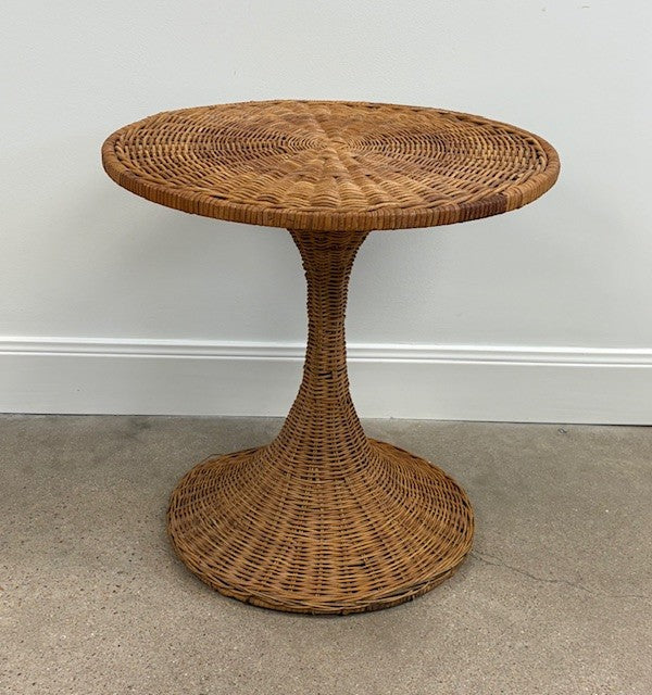 Wicker side table against a plain wall