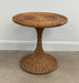 Wicker side table against a plain wall